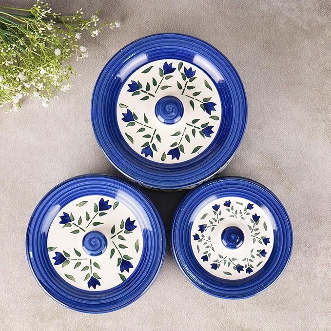 Detailed view of the vibrant blue leaf design on handcrafted ceramic surface.