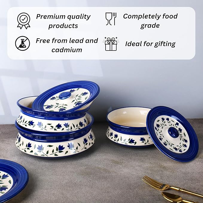 Elegant blue leaf ceramic casserole set with lids placed on a dining table, ideal for serving hot dishes.